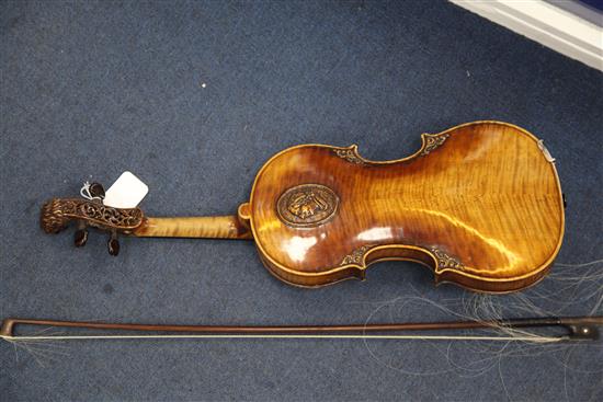 A decorative violin, bearing Gaspar da Salo label, body 14.5in., overall 23.5in., cased with a bow